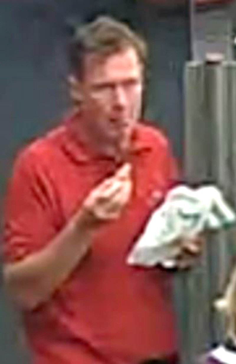 CCTV footage of a man in a red t-shirt released by the BTP after an attempted baby abduction.